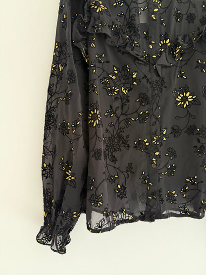 Blouse froufrous noire avec motifs en relief et détails dorés