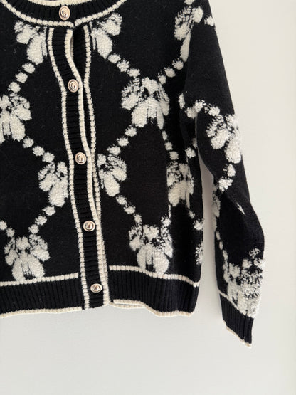 Gilet effet laine noir et blanc avec boutons dorés