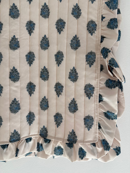 Plastron matelassé crème avec motifs bleus et boutons dans le dos&nbsp;