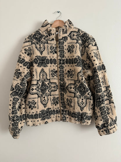 Veste polaire a bouclettes crème avec motifs noirs